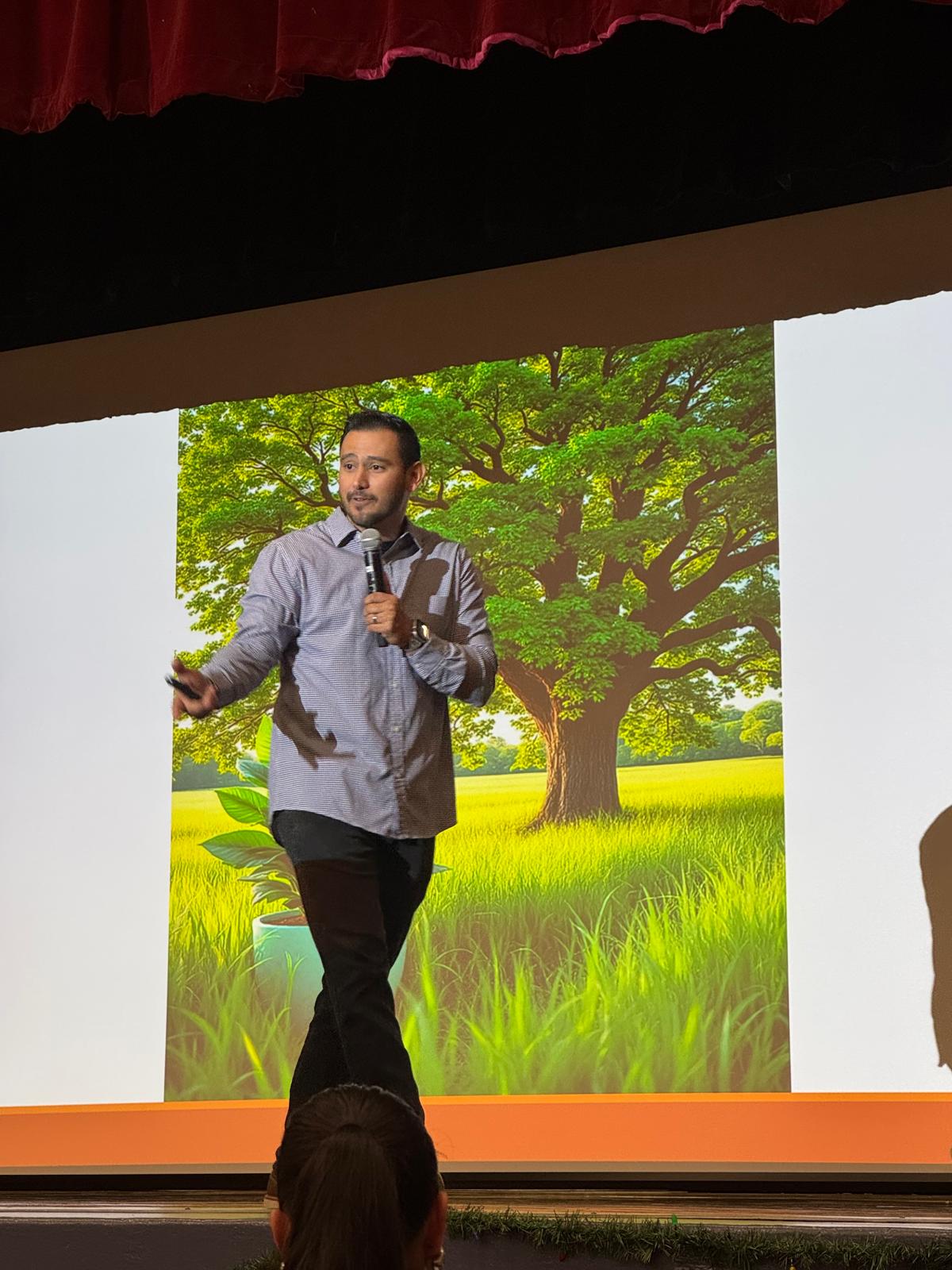 Daniel Rosas speaking on an auditorium stage