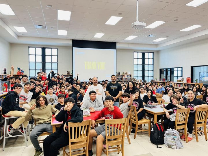 Daniel Rosas with a large group of students after a school presentation
