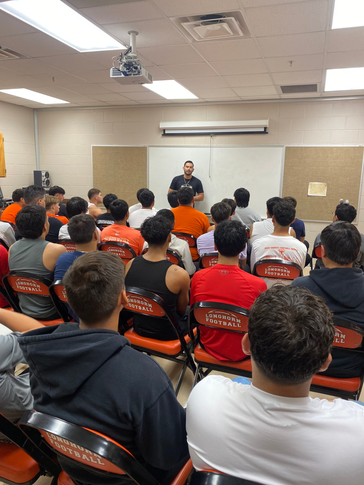 Daniel Rosas leading a session with high school football players