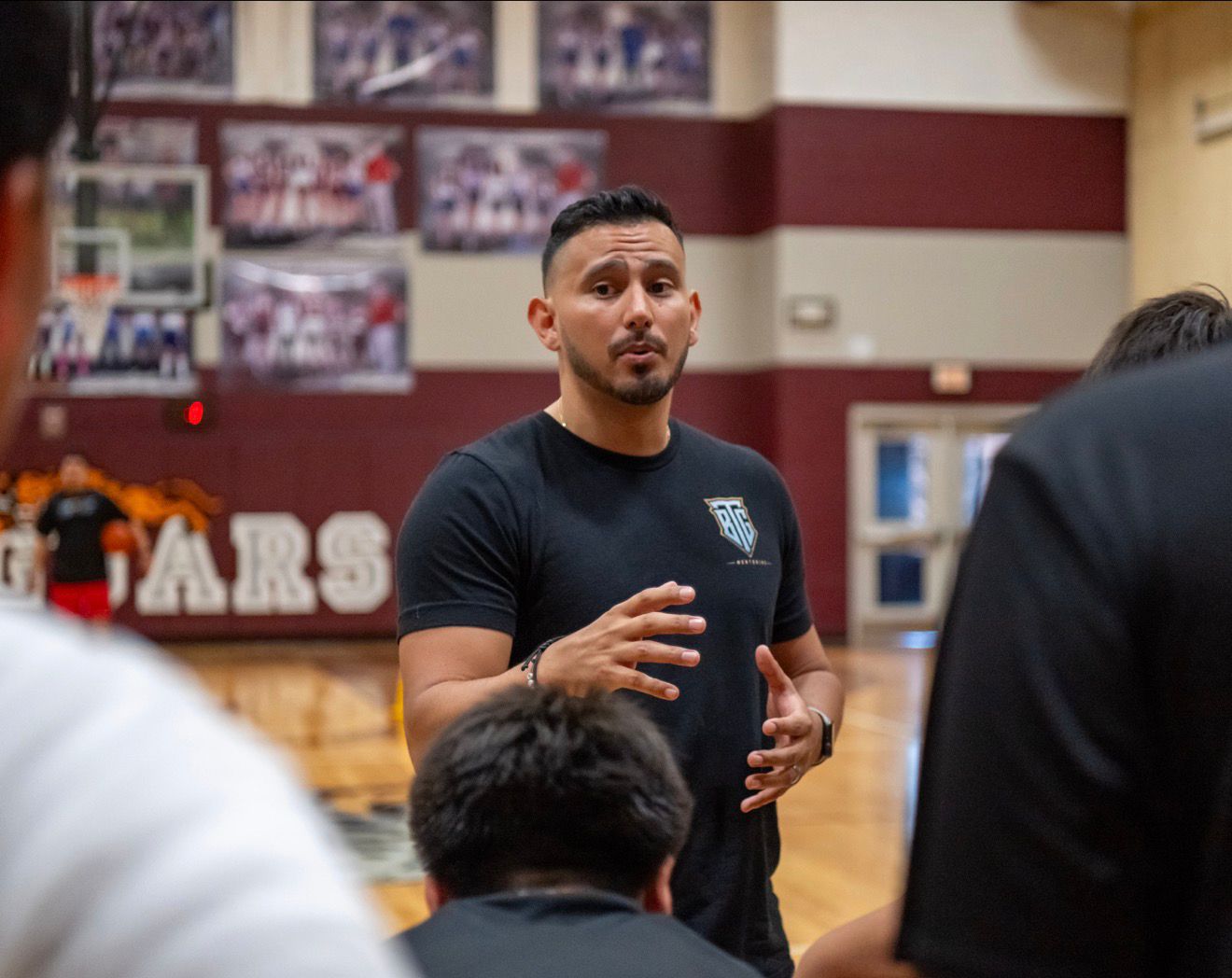 Daniel Rosas coaching athletes in a gym